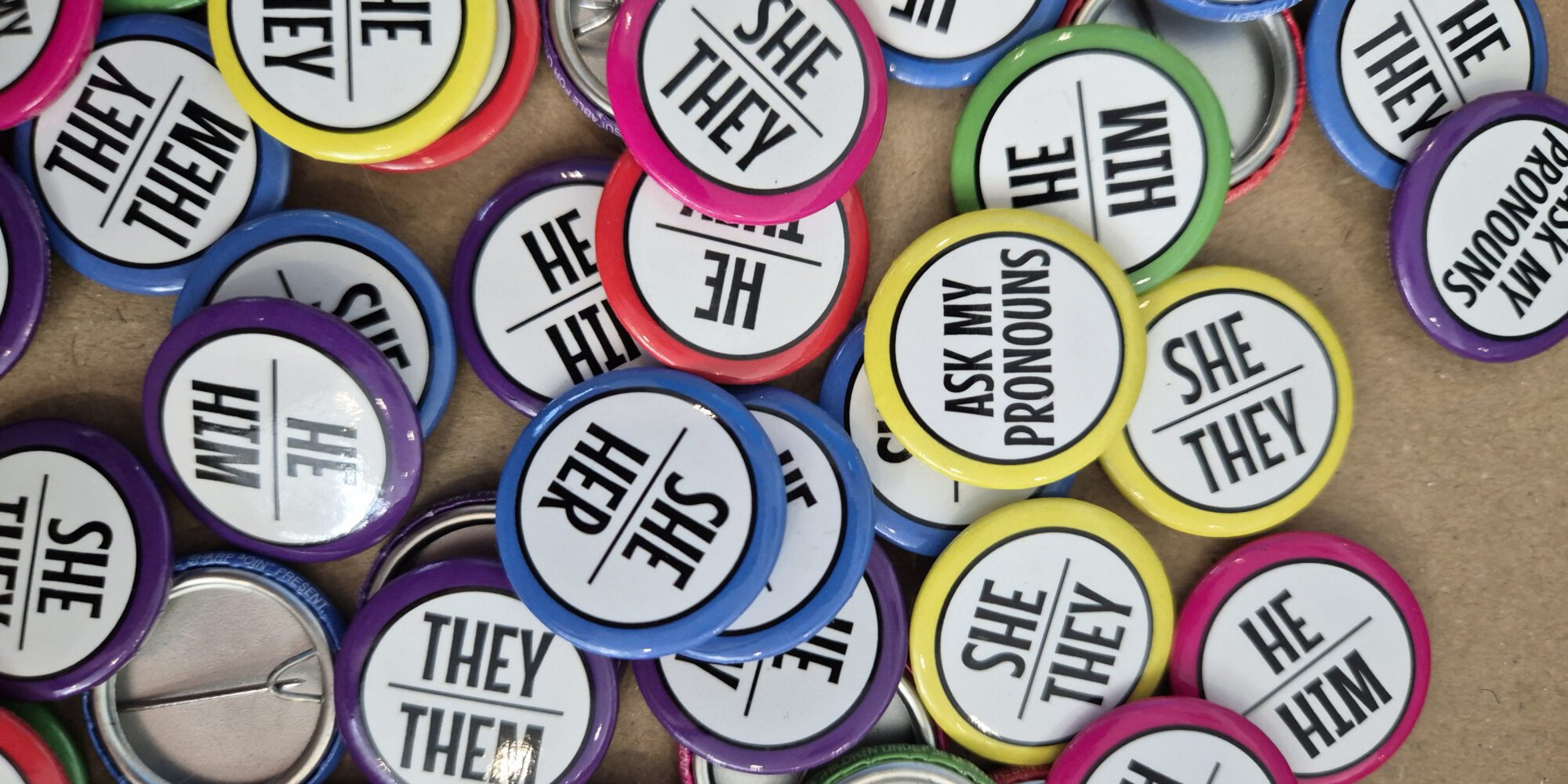 A stock image of different pronoun buttons.